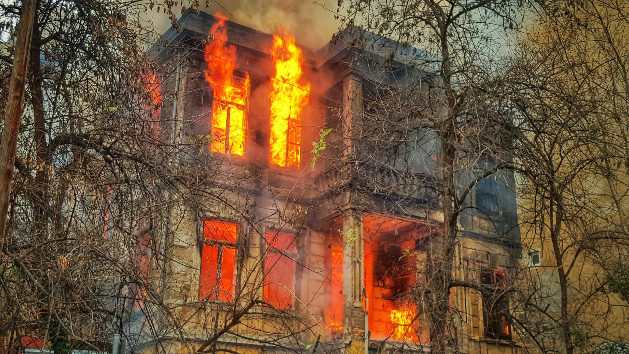 A home engulfed in flames, illustrating the need for safe, post-fire drone damage assessment for insurance claims in Ohio.